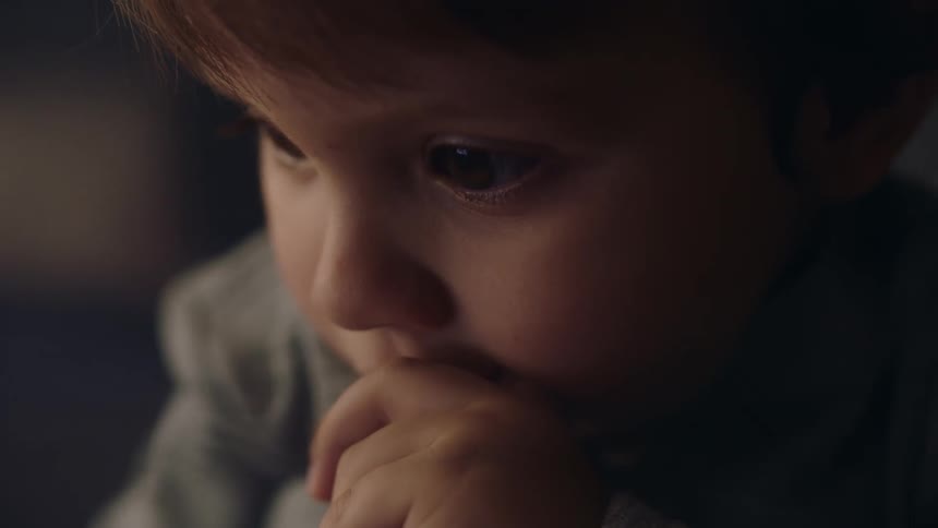 A boy posts with his hand on his chin