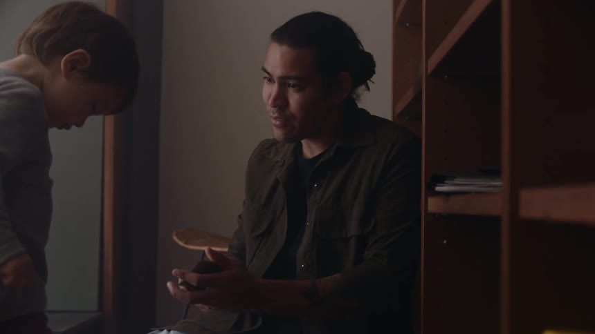 A father is showing cards to his son