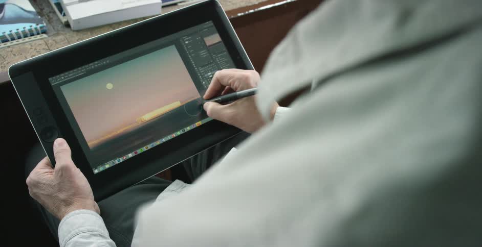 A man is drawing on a tablet