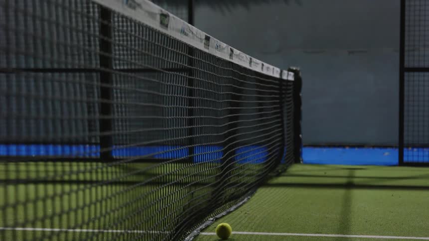 The view is of a tennis court outdoors in the day time