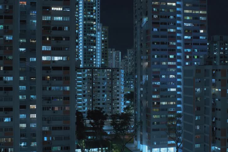 A time lapse of a city with tall buildings and lights on at night