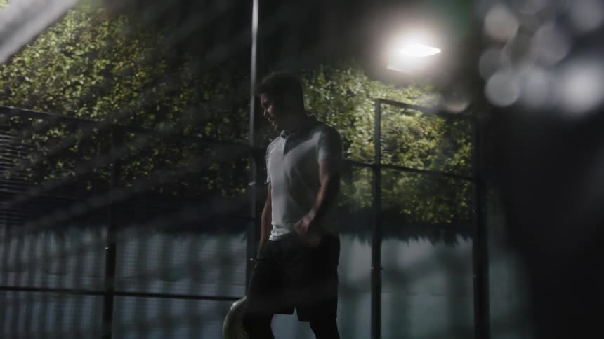 Young active man playing squash on an indoors feels disappointed as he misses a ball
