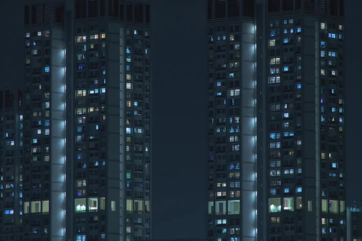 Blue and white window lights turns off inside futuristic towers
