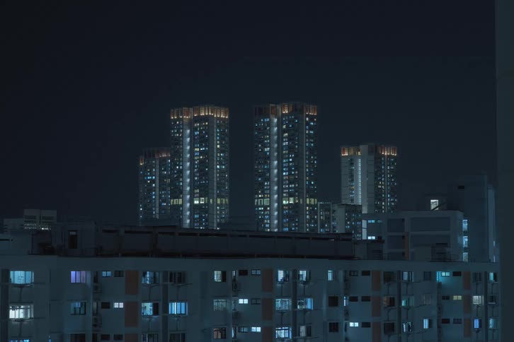 Time lapse of high rise condominiums with lights turning off during the night