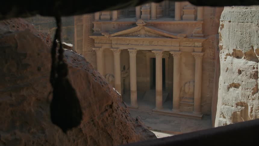 The ruins have large pillars in front