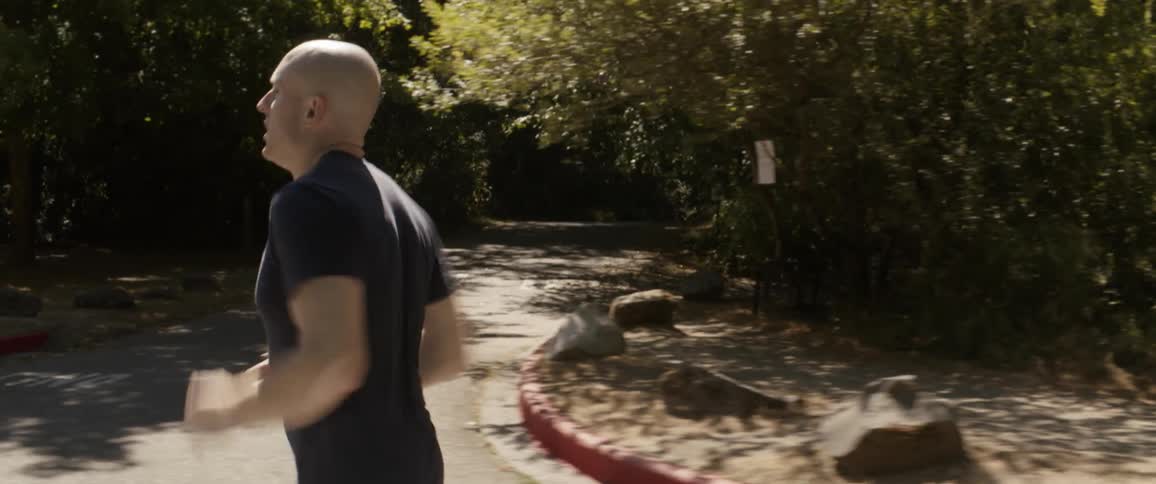 Man jogs along suburban road