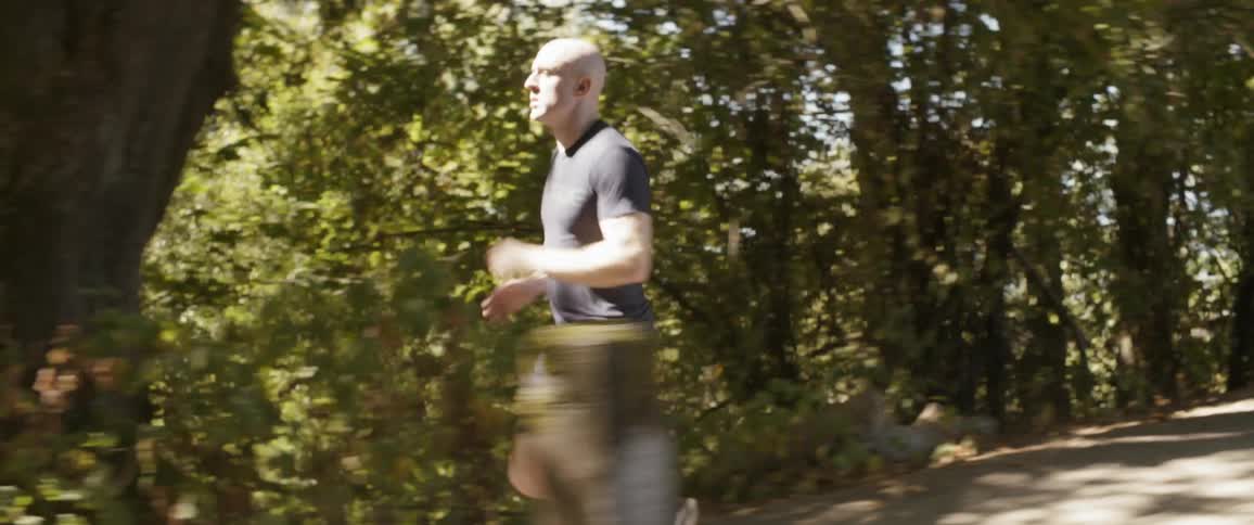 Man runs along park trail
