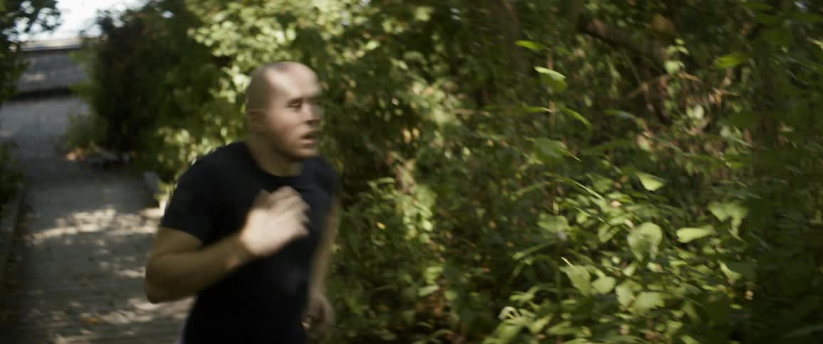 Man runs along park trail