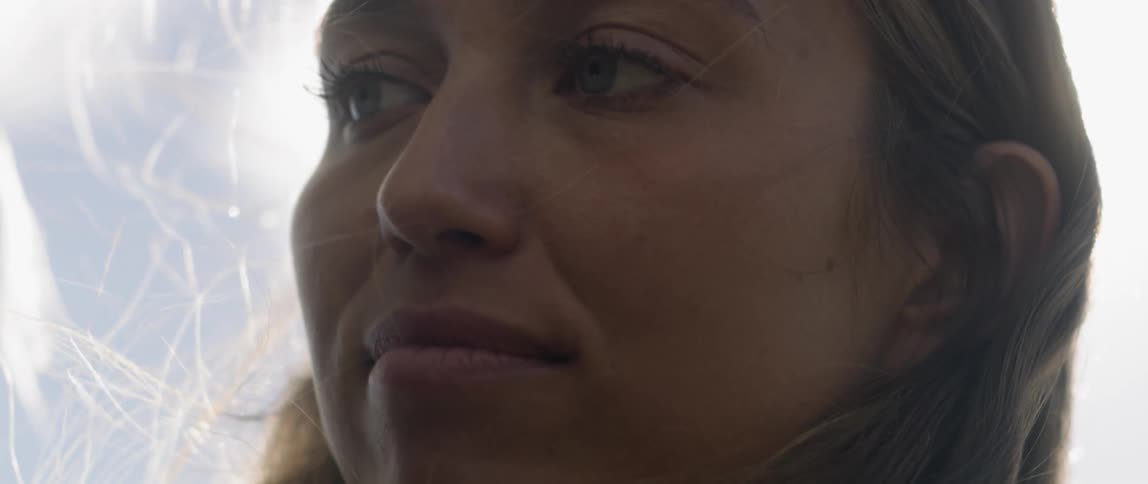 Woman is smiling outside on breezy and sunny day