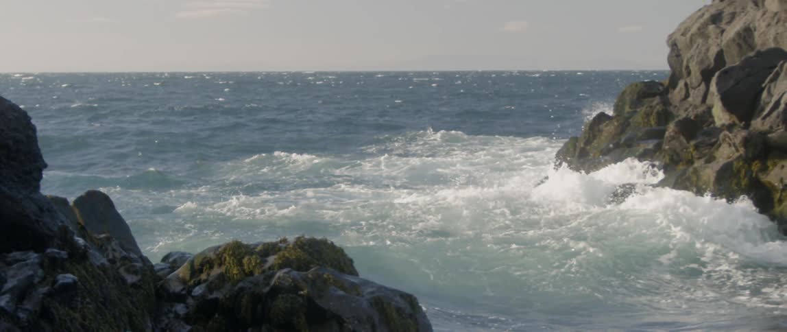 The rough waters splash all over the beach