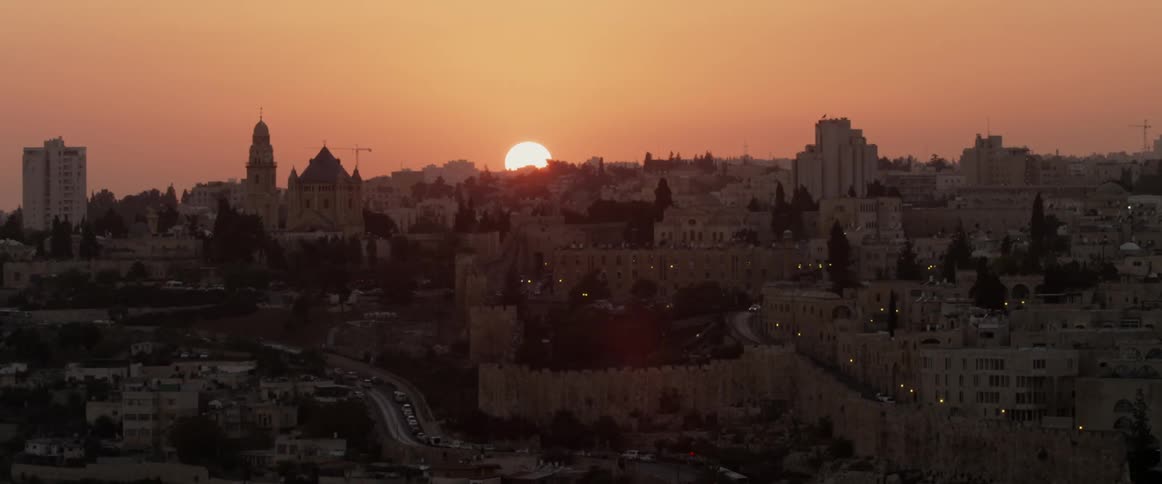 The sun rises over a sprawling city