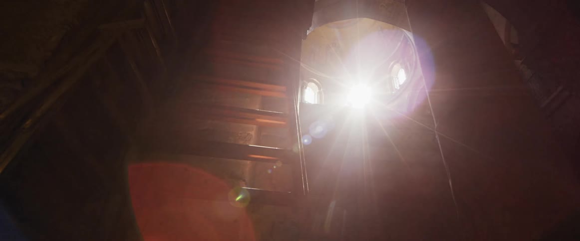 Sunlight shines through the windows of a church dome