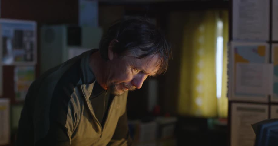A man is looking down in a home