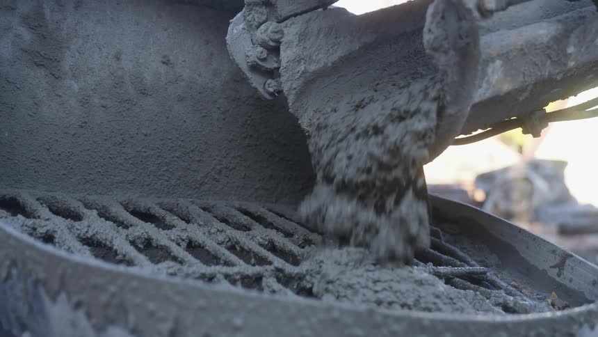 A view of concrete being poured into a hopper
