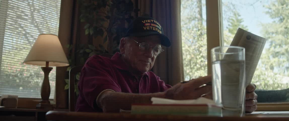 A man begins reading a newspaper