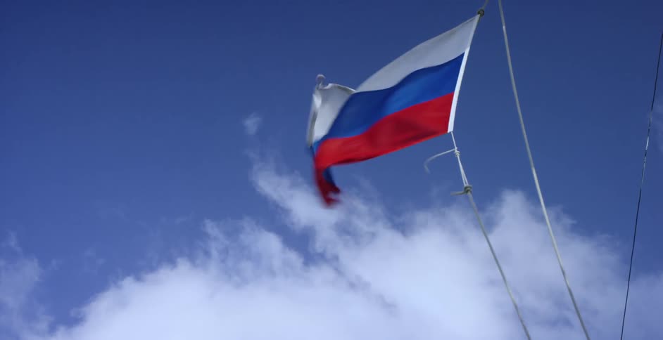 A flag flaps in a strong breeze