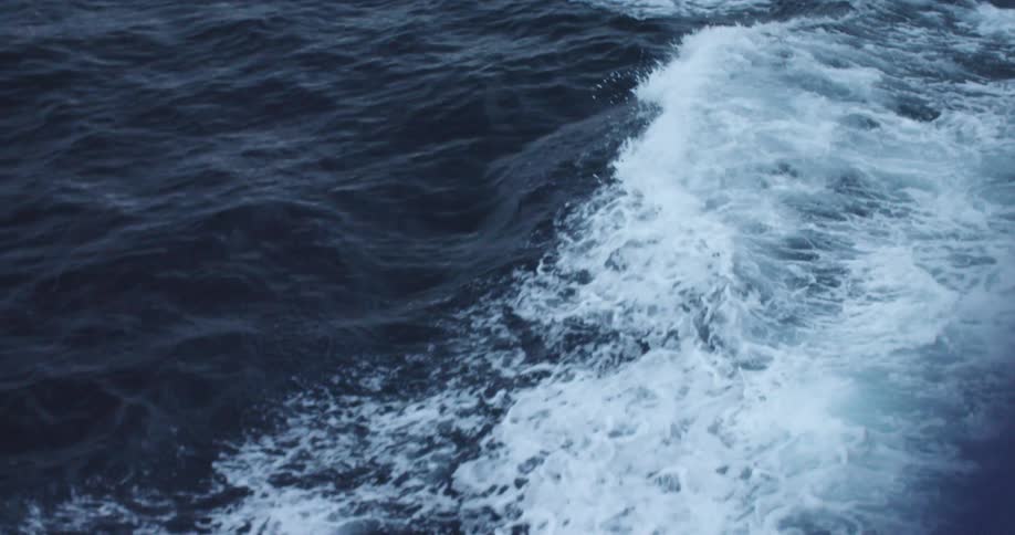 The waves crash below in the water
