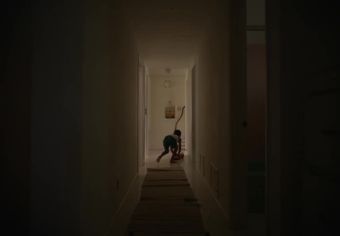 A child pushes his town car down the hall