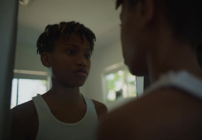 A child looks at himself in the mirror