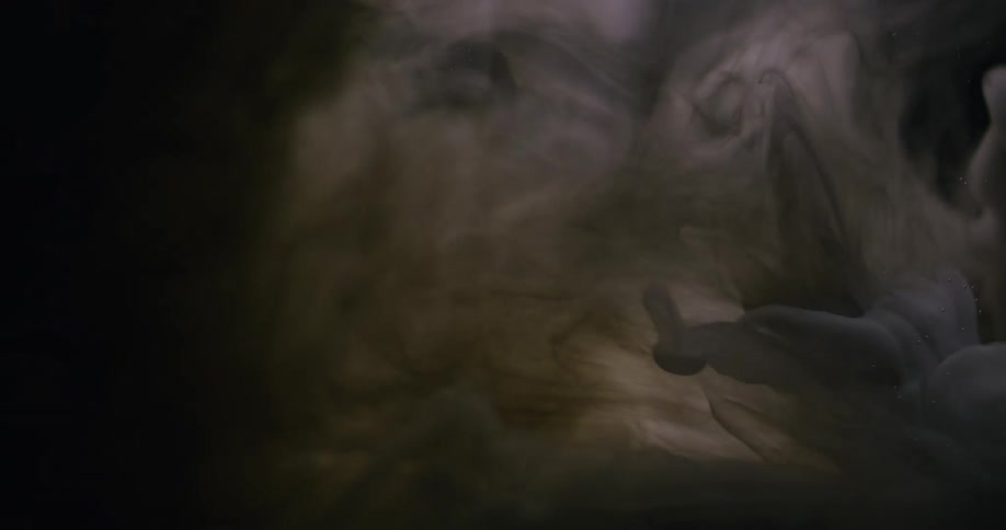 Light flows across slowly moving creamy gaseous mass in dark area