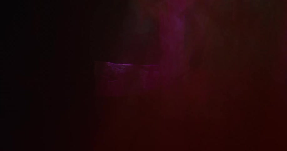 Stone cross seen through a thick red veil waving in the wind