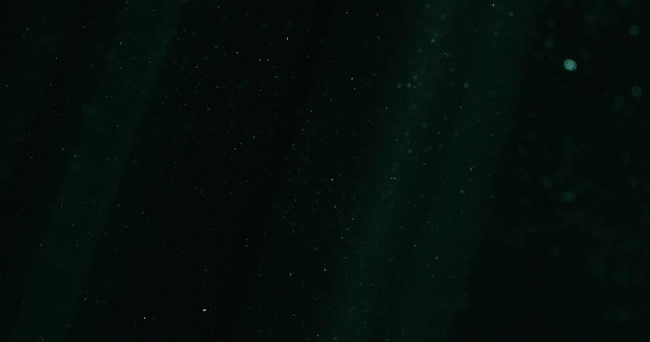 Deep ocean calm almost black tiny bubbles with some light beams coming in