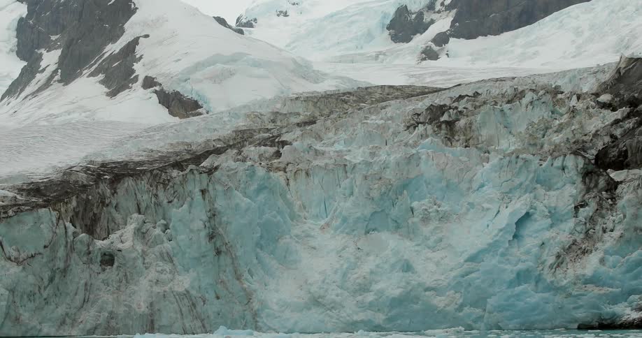 A large ice wall is before this mountain