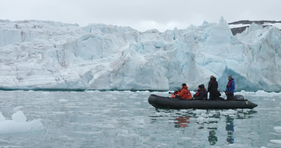 People travel in a raft through icy waters