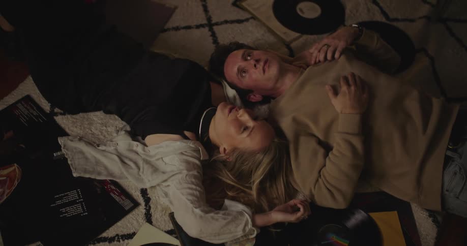 Two people are laying on the ground in their house