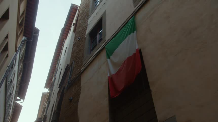 The flag hangs from the building
