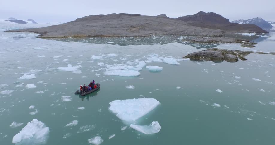 Several people on a small boat in a very cold area