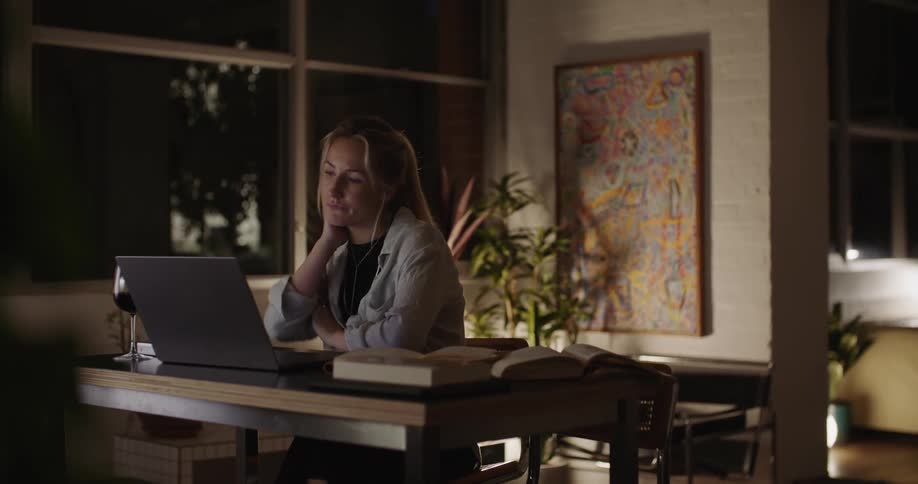 A woman is looking at her laptop