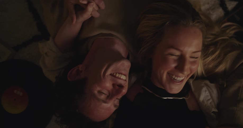 A couople laugh together on the floor