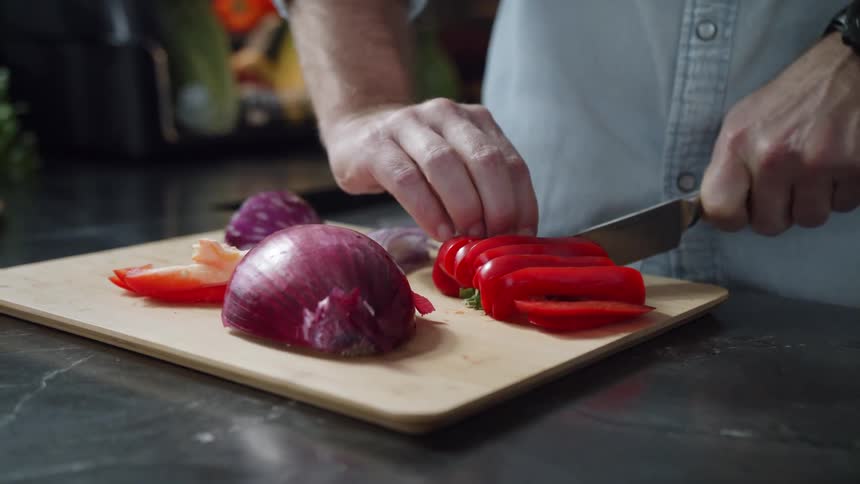 A person is cutting a pepper