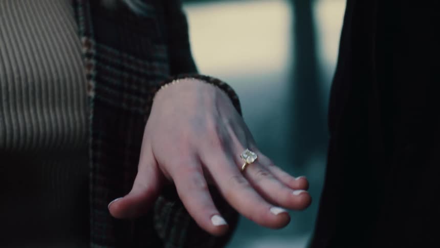 Engagement man places engagement ring on womans finger