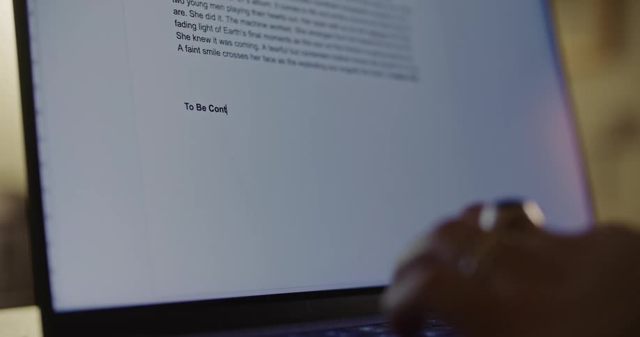 A person is typing words on a laptop