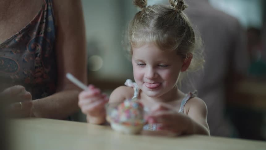 A child getting a cup of ice cream