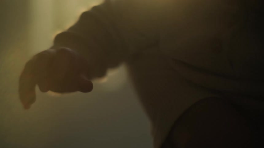 A babys arm dangles while being held