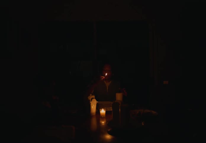Family light candles in the dining room at home during a blackout at night