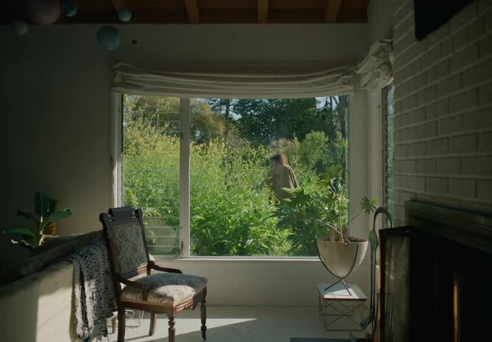 Boys look out the windows overlooking green garden