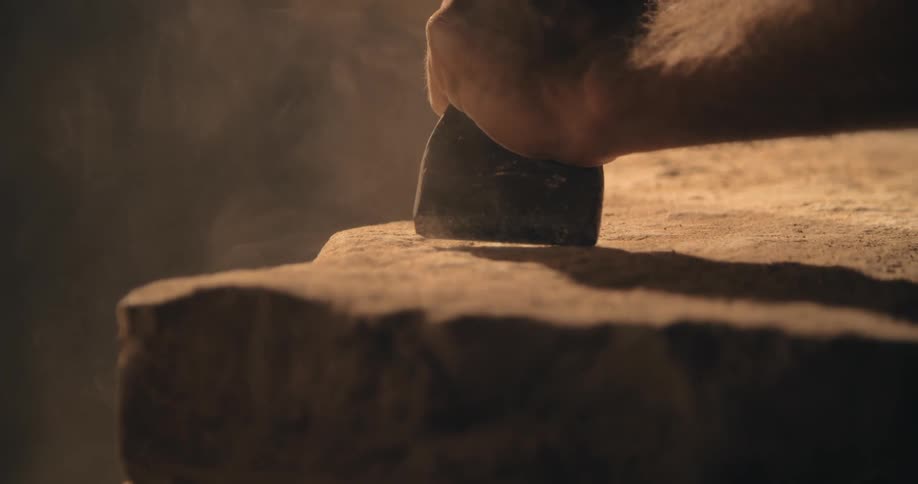 A person is carving stone
