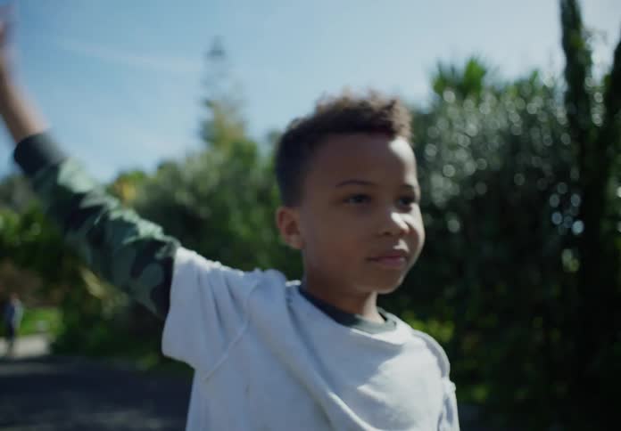 A child waves on the road