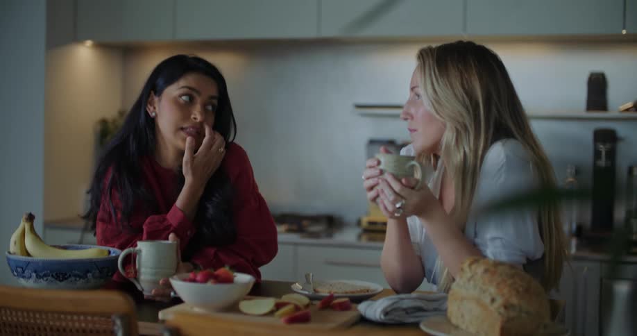 Two friends drink coffee and talk