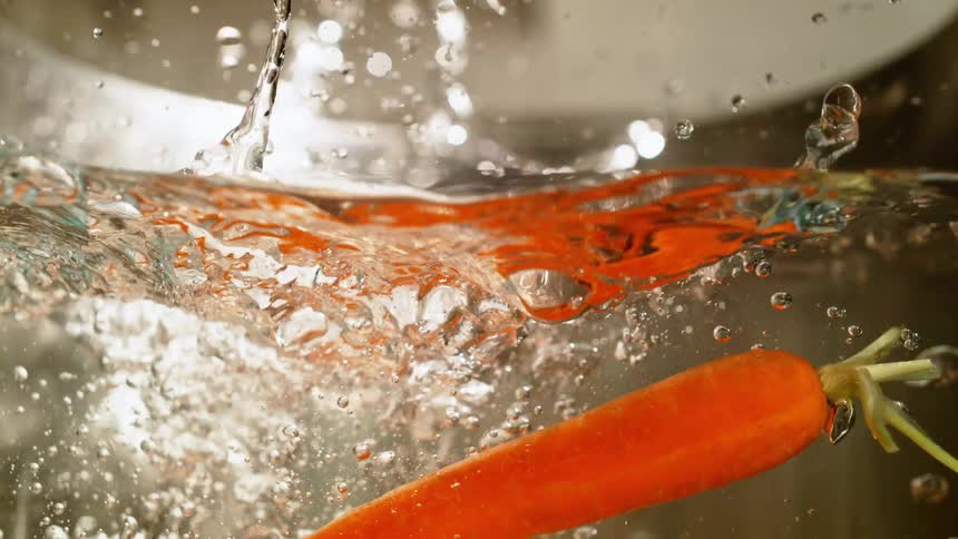 The carrots are dropped into the boiling water