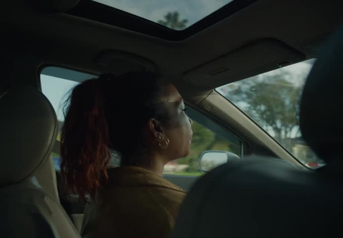 A woman is driving a car