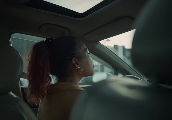 A woman is driving a car