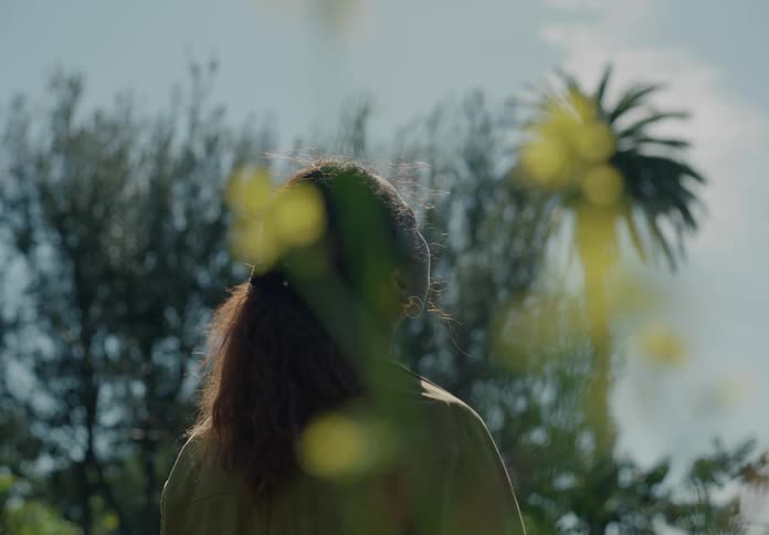 A woman is standing outdoors during spring