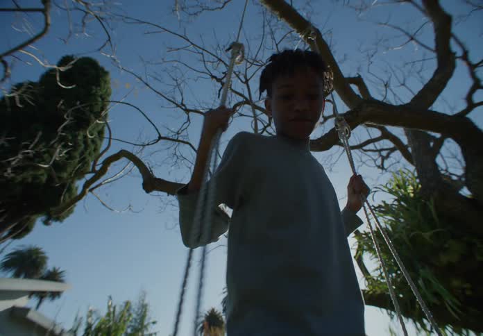 Brothers play on the swing