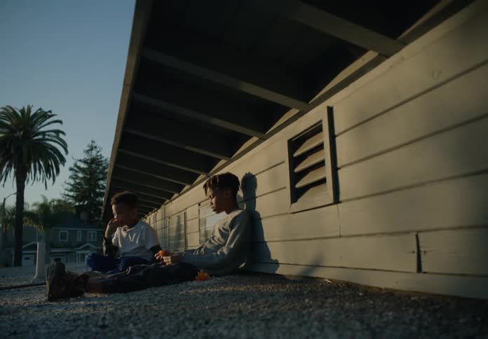 Two children eat on the roof