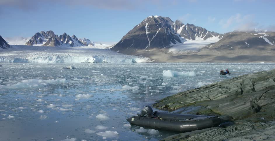 A raft is on the shore of the ice filled water